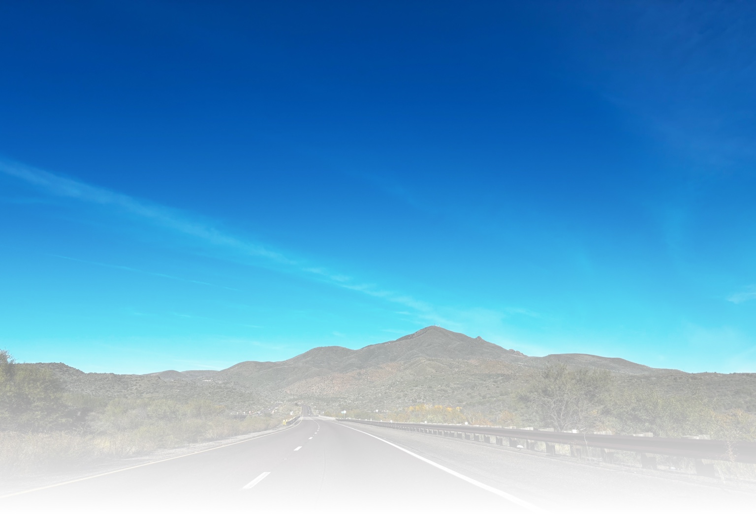 Open road through desert mountains